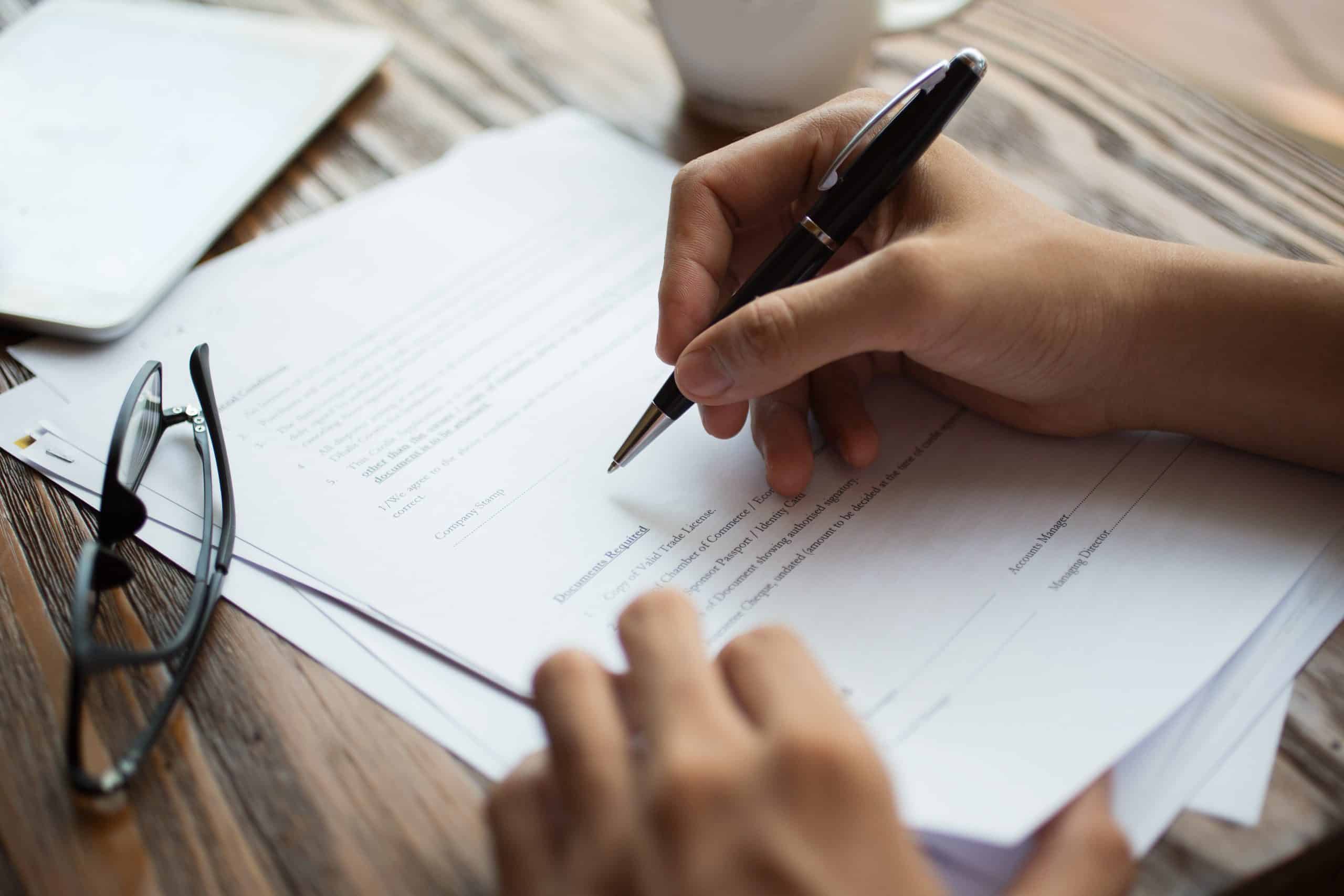 businessman examining papers table